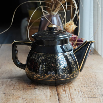 Théière ou cafetière "Théalie" en céramique française noire aux motifs fleuris dorés années 60/70