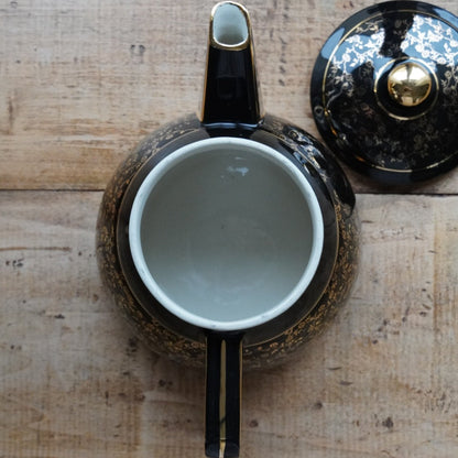 Théière ou cafetière "Théalie" en céramique française noire aux motifs fleuris dorés années 60/70