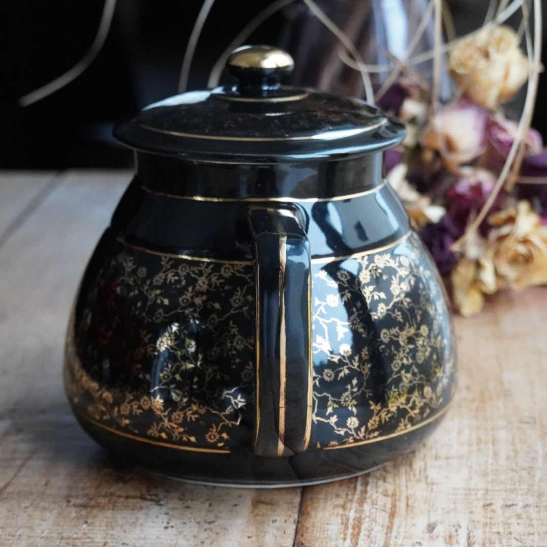Théière ou cafetière "Théalie" en céramique française noire aux motifs fleuris dorés années 60/70