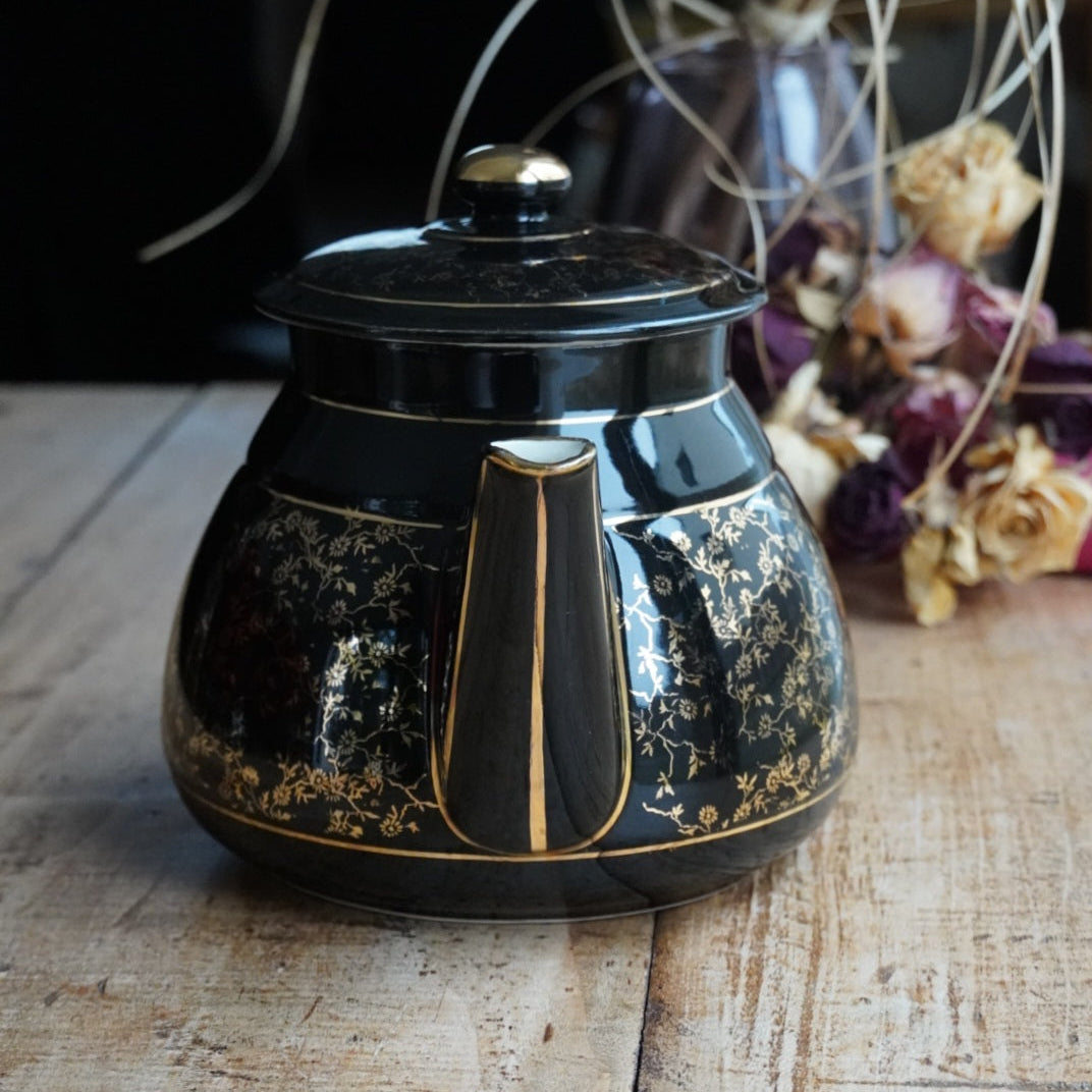 Théière ou cafetière "Théalie" en céramique française noire aux motifs fleuris dorés années 60/70