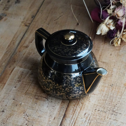 Théière ou cafetière "Théalie" en céramique française noire aux motifs fleuris dorés années 60/70