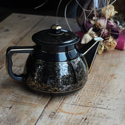 Théière ou cafetière "Théalie" en céramique française noire aux motifs fleuris dorés années 60/70